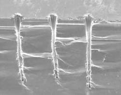 FIGURE 2. A picosecond 532 nm hybrid fiber laser produces high-aspect-ratio percussion-drilled holes in silicon. FIGURE 2. A picosecond 532 nm hybrid fiber laser produces high-aspect-ratio percussion-drilled holes in silicon.
