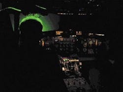 Laser illumination in a dark cockpit at 50-µW/cm2 shows up from the rear as a green halo around subject's head. Laser illumination in a dark cockpit at 50-µW/cm2 shows up from the rear as a green halo around subject's head.