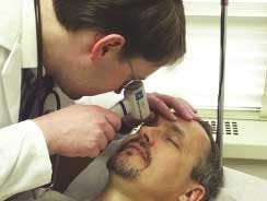 A patient is examined using a handheld Eye Oximeter that measures oxygenation levels in the brain via the retina. A patient is examined using a handheld Eye Oximeter that measures oxygenation levels in the brain via the retina.