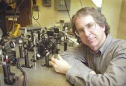 David Nolte demonstrates the laser setup used in combination with detectors and holographic film to create three-dimensional images of the inside of a tumor in real time. David Nolte demonstrates the laser setup used in combination with detectors and holographic film to create three-dimensional images of the inside of a tumor in real time.