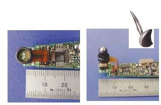 The optical unit for a pen-based personal-computer input device includes a black barrel that houses a vertical-cavity surface-emitting laser centrally located between two double detectors; also included are speckle-processing electronics (left). The barrel holds a 4-mm steel ball that reflects laser light to the detectors that detect ball rotation (right). The assembled pen is linked via radio to its holder (inset).