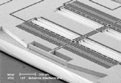 FIGURE 1. Scanning-electron-microscope photograph of the electrostatic actuator of a silicon-based Fourier-transform spectrometer shows the 75 x 500-mm movable mirror, combs, and springs. FIGURE 1. Scanning-electron-microscope photograph of the electrostatic actuator of a silicon-based Fourier-transform spectrometer shows the 75 x 500-mm movable mirror, combs, and springs.