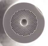 FIGURE 2. An electron micrograph shows a cross section of a low-loss hollow-core PCF designed to operate at telecom wavelengths. The fiber exhibits a minimum attenuation of 1.7 dB/km at 1550 nm. FIGURE 2. An electron micrograph shows a cross section of a low-loss hollow-core PCF designed to operate at telecom wavelengths. The fiber exhibits a minimum attenuation of 1.7 dB/km at 1550 nm.