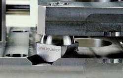 FIGURE 9. A half-spherical, half-cylindrical object called a Spherolinder replaces the spheres traditionally used in a three-groove kinematic mount. FIGURE 9. A half-spherical, half-cylindrical object called a Spherolinder replaces the spheres traditionally used in a three-groove kinematic mount.