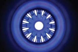 FIGURE 4. Twelve pulsed lamps and a diffuse reflector surround a 32-mm-diameter Nd:glass laser rod, one of 192 preamplifier modules that will provide the light for inertial-confinement fusion reactions at NIF. When fired, each of the 12 lamps can deliver in excess of 1 kJ of pump light to the rod. The rod is used in a four-pass amplifier configuration, boosting pulses from the millijoule regenerative amplifier to the multijoule level. FIGURE 4. Twelve pulsed lamps and a diffuse reflector surround a 32-mm-diameter Nd:glass laser rod, one of 192 preamplifier modules that will provide the light for inertial-confinement fusion reactions at NIF. When fired, each of the 12 lamps can deliver in excess of 1 kJ of pump light to the rod. The rod is used in a four-pass amplifier configuration, boosting pulses from the millijoule regenerative amplifier to the multijoule level.