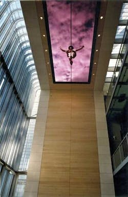 Designed as a 'window on the world,' the 96-panel LED display in the ceiling of the Representanz headquarters of the Bertelsmann Group (Berlin, Germany) measures 10.24 × 2.88 m. It is suspended 12 m above the ground floor. The back of the building is a glass facade, so the screen's 5000 nits brightness is required for the high ambient light levels. The scenes include sky imagery to reflect Berlin's weather, which is then layered with film sequences.