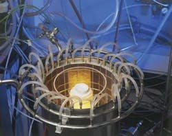 A prototype TPV system is built around a tube-shaped methane burner within a ytterbium oxide mantle emitter that selectively radiates electromagnetic energy matched to the bandgap of the &shy;silicon solar cells attached to water-cooled aluminum plates in the outer diameter. The quartz cylinder surrounding the burner protects the solar cells from hot exhaust gas [5, 6].