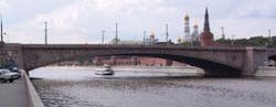 FIGURE 1. The Bolshoi Moskvoretsky Bridge in Moscow, built between 1936 and 1937 near the Kremlin, is part of one of the city's major traffic lines. The bridge consists of three parallel, 100-m-long, reinforced-concrete arches hidden -behind stone walls. Two types of degradation have been detected: settlement in the -center of the arch, which caused cracking of the stone walls near the abutments on both sides of the bridge, and chloride diffusion transversing the upper wall of the arch -boxes. In 2003, 16 interferometric sensors (produced by Smartec) were installed to -continuously monitor structural behavior of the bridge, increase safety, and reduce maintenance costs. FIGURE 1. The Bolshoi Moskvoretsky Bridge in Moscow, built between 1936 and 1937 near the Kremlin, is part of one of the city's major traffic lines. The bridge consists of three parallel, 100-m-long, reinforced-concrete arches hidden -behind stone walls. Two types of degradation have been detected: settlement in the -center of the arch, which caused cracking of the stone walls near the abutments on both sides of the bridge, and chloride diffusion transversing the upper wall of the arch -boxes. In 2003, 16 interferometric sensors (produced by Smartec) were installed to -continuously monitor structural behavior of the bridge, increase safety, and reduce maintenance costs.