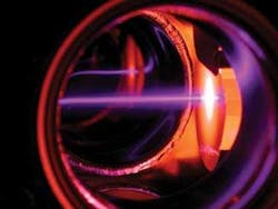 Laser light at 401 nm (traveling from left to right in this photo) slows erbium atoms exiting an oven. Laser light at 401 nm (traveling from left to right in this photo) slows erbium atoms exiting an oven.