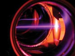 Laser light at 401 nm (traveling from left to right in this photo) slows erbium atoms exiting an oven.