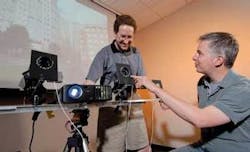 Doctoral student Jay Summet (left) and James Clawson, a research technician, demonstrate a prototype device designed to detect and neutralize CCDs in digital cameras. Doctoral student Jay Summet (left) and James Clawson, a research technician, demonstrate a prototype device designed to detect and neutralize CCDs in digital cameras.