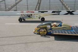FIGURE 2. In the final phase of the Dell-Winston Solar Car Challenge, Sundancer, powered by an array of Schott solar cells, passes a competitor. FIGURE 2. In the final phase of the Dell-Winston Solar Car Challenge, Sundancer, powered by an array of Schott solar cells, passes a competitor.