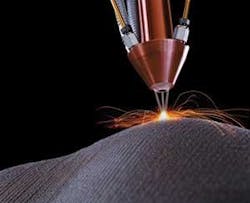 FIGURE 1. For laser cladding applications, powder blown through a nozzle or nozzles is sintered using heat from the central laser beam. FIGURE 1. For laser cladding applications, powder blown through a nozzle or nozzles is sintered using heat from the central laser beam.