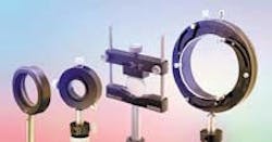 FIGURE 1. Assortment of post-mounted commercial lens holders includes, from left to right, a fixed lens holder using a retaining ring, a translating lens holder, an adjustable lens holder, and a self-centering lens holder. FIGURE 1. Assortment of post-mounted commercial lens holders includes, from left to right, a fixed lens holder using a retaining ring, a translating lens holder, an adjustable lens holder, and a self-centering lens holder.