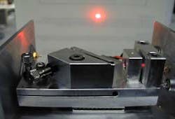 The linewidth of a 657-nm-emitting laser diode is reduced to below 30 Hz. A holographic grating (at center) forming an extended cavity provides fine frequency tuning, while large frequency excursions are compensated for by a fast injection-current feedback loop. A Fabry-Perot resonator provides the frequency reference. The linewidth of a 657-nm-emitting laser diode is reduced to below 30 Hz. A holographic grating (at center) forming an extended cavity provides fine frequency tuning, while large frequency excursions are compensated for by a fast injection-current feedback loop. A Fabry-Perot resonator provides the frequency reference.