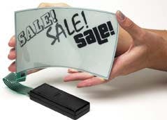 FIGURE 5. A flexible display based on electrophoretic ink is intended for point-of-purchase advertising signs. In this case, individual words can be switched on and off in an arbitrarily selected sequence. The sign, which has the thickness and flexibility of cardboard, runs for months on two AA batteries. FIGURE 5. A flexible display based on electrophoretic ink is intended for point-of-purchase advertising signs. In this case, individual words can be switched on and off in an arbitrarily selected sequence. The sign, which has the thickness and flexibility of cardboard, runs for months on two AA batteries.