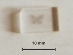 Focused femtosecond pulses increase the valence state of manganese ions in clear doped glass, causing the glass to become purple. With a moving focused spot, structures such as this butterfly can be written in glass.