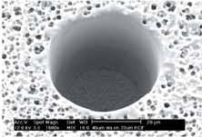 FIGURE 3. Via platforms, such as this 45-μm via formed through a resin dielectric layer, are enabling the trend toward component integration. FIGURE 3. Via platforms, such as this 45-μm via formed through a resin dielectric layer, are enabling the trend toward component integration.