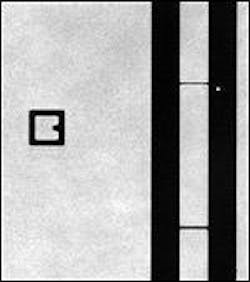 FIGURE 1. A binary (non-phase-shifting) mask is imaged at 100x with 193-nm light from a solid-state laser source. A 200-nm probe spot, arising from the same laser source, can be seen next to a 200-nm bridge.