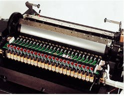 FIGURE 3. System based on an array of 24 fiber-coupled 550-mW lasers along a cylinder prints two-page format. FIGURE 3. System based on an array of 24 fiber-coupled 550-mW lasers along a cylinder prints two-page format.