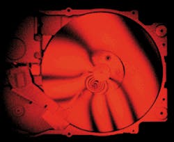 Circular fringes of holographic interferogram of bolt of computer disk drive indicate tightening, causing a 750-µm distortion in the media. Circular fringes of holographic interferogram of bolt of computer disk drive indicate tightening, causing a 750-µm distortion in the media.