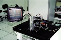 FIGURE 1. Laser diode broad-area test station measures device characteristics immediately after crystal growth; a video system facilitates probe positioning at the start of testing. FIGURE 1. Laser diode broad-area test station measures device characteristics immediately after crystal growth; a video system facilitates probe positioning at the start of testing.
