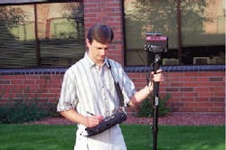 FIGURE 1. The Scene Pro would bring several optoelectronic tools to the crime scene. This computer on a shoulder strap is linked to a video camera with a laser rangefinder on top that will allow police to find and keep track of evidence more efficiently. FIGURE 1. The Scene Pro would bring several optoelectronic tools to the crime scene. This computer on a shoulder strap is linked to a video camera with a laser rangefinder on top that will allow police to find and keep track of evidence more efficiently.