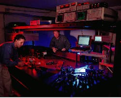 Eric Wachter (left), chief scientist at Photogen Technologies (Knoxville, TN), and Walt Fisher, another Photogen researcher, prepare to test a new feature of the company`s two-photon technology that uses a proprietary software program to position the laser and move its focal point within a defined three-dimensional tissue space. The system is being developed for use in the treatment of melanoma and other cancers. Eric Wachter (left), chief scientist at Photogen Technologies (Knoxville, TN), and Walt Fisher, another Photogen researcher, prepare to test a new feature of the company`s two-photon technology that uses a proprietary software program to position the laser and move its focal point within a defined three-dimensional tissue space. The system is being developed for use in the treatment of melanoma and other cancers.