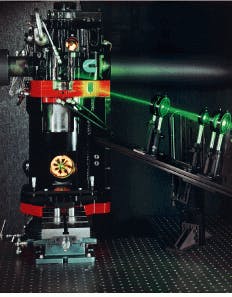 FIGURE 2. Modifications to the diesel engine used for research include installation of quartz windows at the top and bottom of the combustion chamber so that mirrors can image the combustion process. A sheet of laser light enters the combustion chamber through a smaller window in the cylinder wall. The research engine retains the basic geometry of a Cummins production heavy duty diesel engine. FIGURE 2. Modifications to the diesel engine used for research include installation of quartz windows at the top and bottom of the combustion chamber so that mirrors can image the combustion process. A sheet of laser light enters the combustion chamber through a smaller window in the cylinder wall. The research engine retains the basic geometry of a Cummins production heavy duty diesel engine.