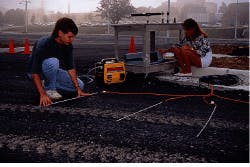 FIGURE 1. Virginia Tech students Dave Forbis and Cindi Grinder install extrinsic Fabry-Perot interferometric fiberoptic sensors in testbed on Virginia Tech campus. The sensors were later covered with asphalt. FIGURE 1. Virginia Tech students Dave Forbis and Cindi Grinder install extrinsic Fabry-Perot interferometric fiberoptic sensors in testbed on Virginia Tech campus. The sensors were later covered with asphalt.