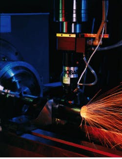 High-speed end effector uses capacitive height sensing and an independent axis to maintain proper nozzle-to-workpiece position for cutting with an industrial Nd:YAG laser. High-speed end effector uses capacitive height sensing and an independent axis to maintain proper nozzle-to-workpiece position for cutting with an industrial Nd:YAG laser.