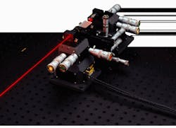 FIGURE 1. Four-axis manipulator positions a fiberoptic telecommunications waveguide between two three-axis stages for production quality testing. Coarse optics adjustments to within 50 nm are made with manual micrometers and are further refined by an order of magnitude with piezo actuators. FIGURE 1. Four-axis manipulator positions a fiberoptic telecommunications waveguide between two three-axis stages for production quality testing. Coarse optics adjustments to within 50 nm are made with manual micrometers and are further refined by an order of magnitude with piezo actuators.