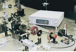 FIGURE 1. Recovery of femtosecond signals in transient absorption spectroscopy is done with a dual-phase lock-in amplifier at the Rutherford Appleton Laboratory (Oxfordshire, England). A pulsed-source laser beam is passed through a rotating chopper (right foreground) before being split into a reference and sample probe beams. Ratio of the intensity of the reference beam to that passing through the sample is then determined. FIGURE 1. Recovery of femtosecond signals in transient absorption spectroscopy is done with a dual-phase lock-in amplifier at the Rutherford Appleton Laboratory (Oxfordshire, England). A pulsed-source laser beam is passed through a rotating chopper (right foreground) before being split into a reference and sample probe beams. Ratio of the intensity of the reference beam to that passing through the sample is then determined.