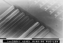 FIGURE 1. Eight-fiber optical fiber ribbon coupled to a flip-chip-mounted eight-laser array is fabricated on a silicon submount. The pitch of the fibers is 250 µm. FIGURE 1. Eight-fiber optical fiber ribbon coupled to a flip-chip-mounted eight-laser array is fabricated on a silicon submount. The pitch of the fibers is 250 µm.