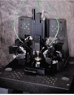 FIGURE 2. In a laser welder having micron accuracy, positioners precisely locate and hold optoelectronic components and optical fibers for pigtailing and connector attachment during high-volume automated production operations. FIGURE 2. In a laser welder having micron accuracy, positioners precisely locate and hold optoelectronic components and optical fibers for pigtailing and connector attachment during high-volume automated production operations.