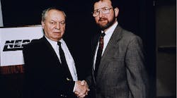 Frank Kulesza (left), founder of Epoxy Technology, congratulates Richard Estes, vice president of technical operations, on formation of spin-off company Polymer Flip-Chip Corp. Frank Kulesza (left), founder of Epoxy Technology, congratulates Richard Estes, vice president of technical operations, on formation of spin-off company Polymer Flip-Chip Corp.