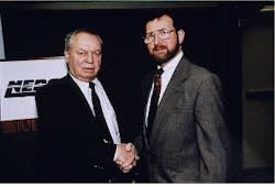 Frank Kulesza (left), founder of Epoxy Technology, congratulates Richard Estes, vice president of technical operations, on formation of spin-off company Polymer Flip-Chip Corp. Frank Kulesza (left), founder of Epoxy Technology, congratulates Richard Estes, vice president of technical operations, on formation of spin-off company Polymer Flip-Chip Corp.