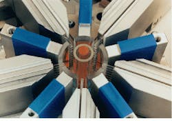 FIGURE 2. High-power diode-laser pumping modules with fiber-coupled lasers transversally excite a Nd:YAG rod. The rod is fixed for cooling in a flow tube (center). A cylindrical reflecting element is mounted opposite each fiber array. FIGURE 2. High-power diode-laser pumping modules with fiber-coupled lasers transversally excite a Nd:YAG rod. The rod is fixed for cooling in a flow tube (center). A cylindrical reflecting element is mounted opposite each fiber array.