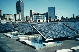 Northeastern University Ell Student Center hosts an 18-kW grid-connected array of photovoltaic cells on its roof. The Boston skyline is in the background.