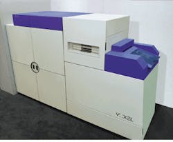 FIGURE 1. Elements of three laboratory rooms, two laser optical systems, and a film-processing room were combined to make the Voxcam, a 3 x 8-ft holographic laser-based camera system used to convert digital data from CT or MR scans into Voxgrams. FIGURE 1. Elements of three laboratory rooms, two laser optical systems, and a film-processing room were combined to make the Voxcam, a 3 x 8-ft holographic laser-based camera system used to convert digital data from CT or MR scans into Voxgrams.
