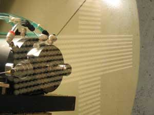 FIGURE 2. Ultraprecision diamond milling is used to produce hard tools for wafer-level replication. Many identical lenses are machined on a 200 mm hard tool for subsequent replication. The asphere profile can be a high-NA, large sag lens.