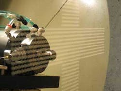 FIGURE 2. Ultraprecision diamond milling is used to produce hard tools for wafer-level replication. Many identical lenses are machined on a 200 mm hard tool for subsequent replication. The asphere profile can be a high-NA, large sag lens. FIGURE 2. Ultraprecision diamond milling is used to produce hard tools for wafer-level replication. Many identical lenses are machined on a 200 mm hard tool for subsequent replication. The asphere profile can be a high-NA, large sag lens.