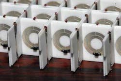 FIGURE 1. Split-ring resonators are shown arranged in a uniformly spaced array in a negative-index metamaterial for microwave frequencies. Optical metamaterials use nanometer-scale elements. FIGURE 1. Split-ring resonators are shown arranged in a uniformly spaced array in a negative-index metamaterial for microwave frequencies. Optical metamaterials use nanometer-scale elements.