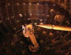 FIGURE 3. The interior of the NIF target chamber showing optics that focus beams onto the target held at the top of the target positioner at right. Technicians are in a service module at left.