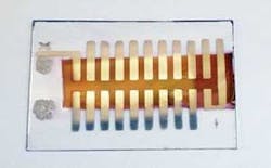 Twenty miniature organic solar cells are connected in series to create a 2.2 cm2 solar array that is close to creating enough voltage to power a tiny microelectromechanical system (MEMS) device. The overall device is one square inch in size, and each of the solar cells has an active area of 1 mm2. Twenty miniature organic solar cells are connected in series to create a 2.2 cm2 solar array that is close to creating enough voltage to power a tiny microelectromechanical system (MEMS) device. The overall device is one square inch in size, and each of the solar cells has an active area of 1 mm2.