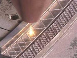 FIGURE 4. Laser additive manufacturing can be used to build the thin 0.3 mm walls for the lattice on an aerospace component. The lattice is filled with a ceramic to form a seal against the blade that rubs against it. FIGURE 4. Laser additive manufacturing can be used to build the thin 0.3 mm walls for the lattice on an aerospace component. The lattice is filled with a ceramic to form a seal against the blade that rubs against it.