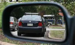 A standard rear-view mirror has a field of view of only 15° to 20°, which results in the familiar blind spot (top). A properly shaped free-form reflector placed in exactly the same orientation (bottom) has a 45° field of view, eliminating the blind spot without producing the distorted scene that other wide-angle mirrors create.