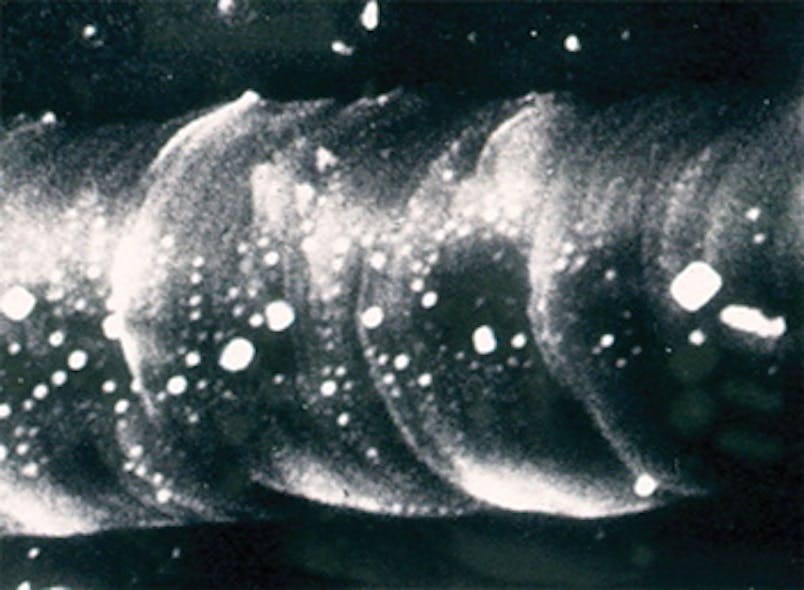 FIGURE 2. A secondary electron micrograph shows grains of KBr remaining embedded in the melted diamond after the face was rinsed in water.