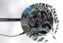 FIGURE 3. A compact disk rotated at 23,000 rpm starts to warp and then shatters into small pieces; the image is captured at 170,000 frames/s. FIGURE 3. A compact disk rotated at 23,000 rpm starts to warp and then shatters into small pieces; the image is captured at 170,000 frames/s.