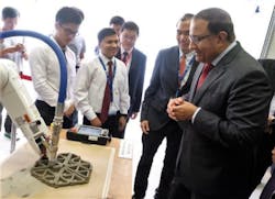 (Right) Minister of Industry Mr. S. Iswaran looking at a 3D printing robot being developed at NTU that can print concrete structures. (Right) Minister of Industry Mr. S. Iswaran looking at a 3D printing robot being developed at NTU that can print concrete structures.